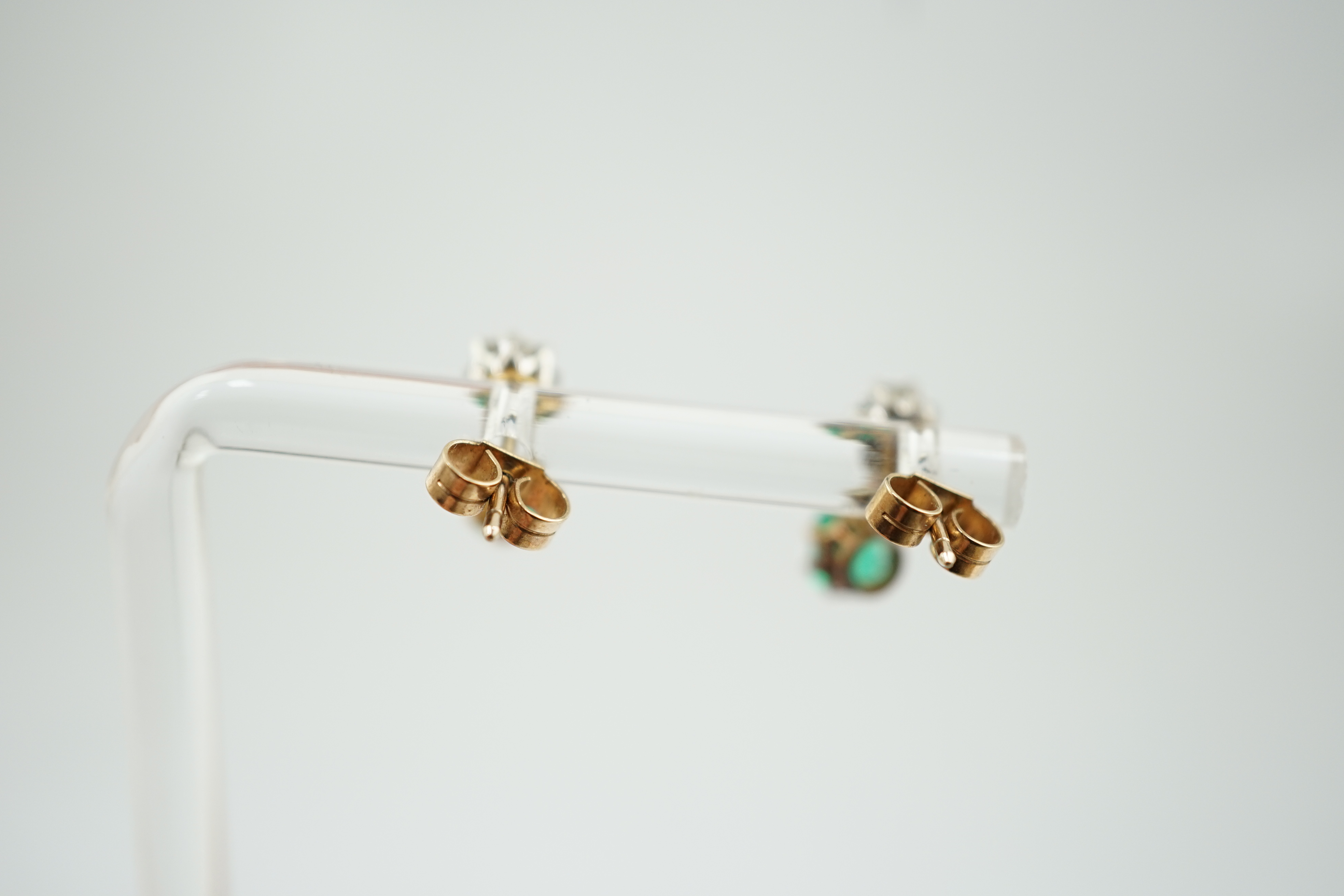 A pair of late 19th/early 20th century gold and platinum, emerald and diamond set two stone drop earrings